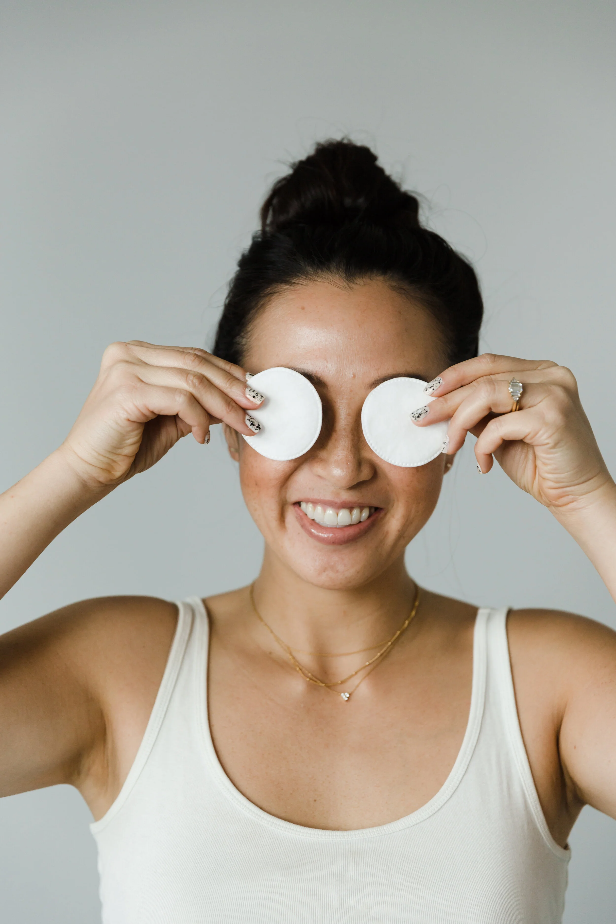 Person holding under-eye patches below their eyes