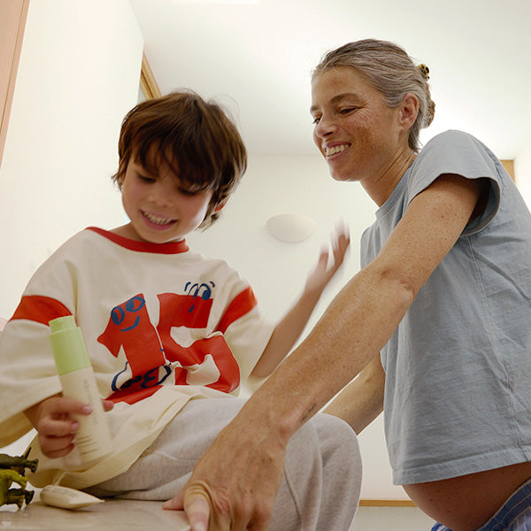 Parent and child sharing a playful skincare moment