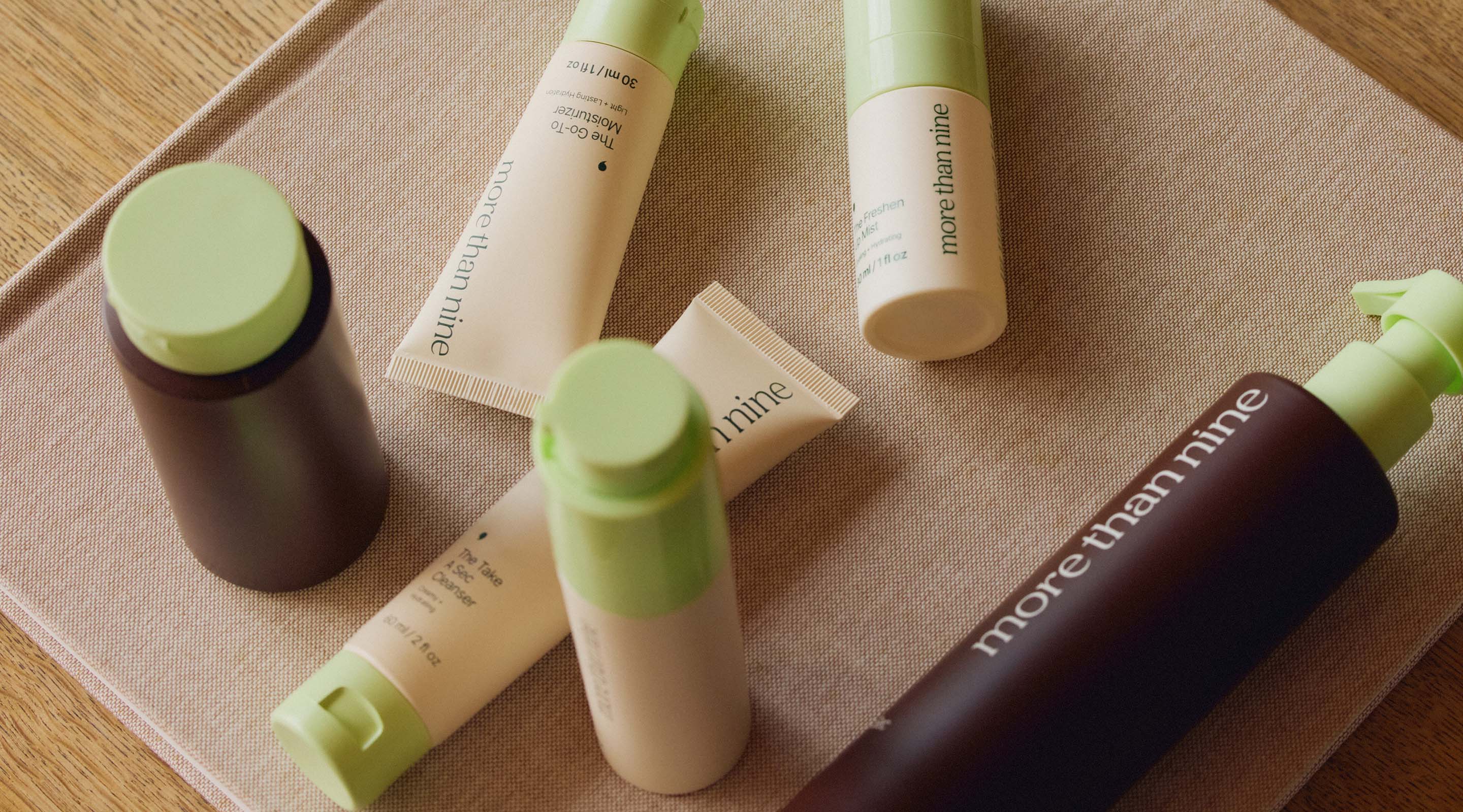 More Than Nine skincare bottles and tubes on a neutral surface