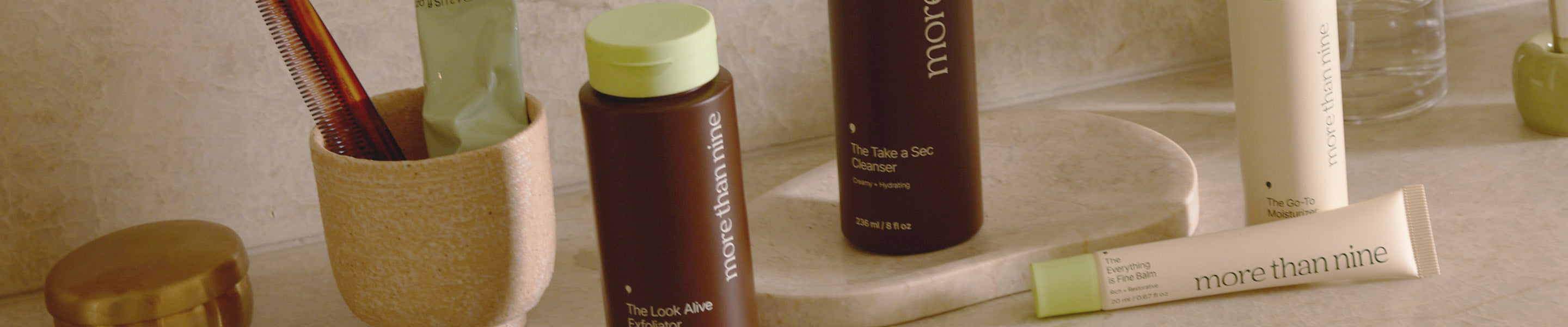 More Than Nine skincare products lined up on a bathroom counter