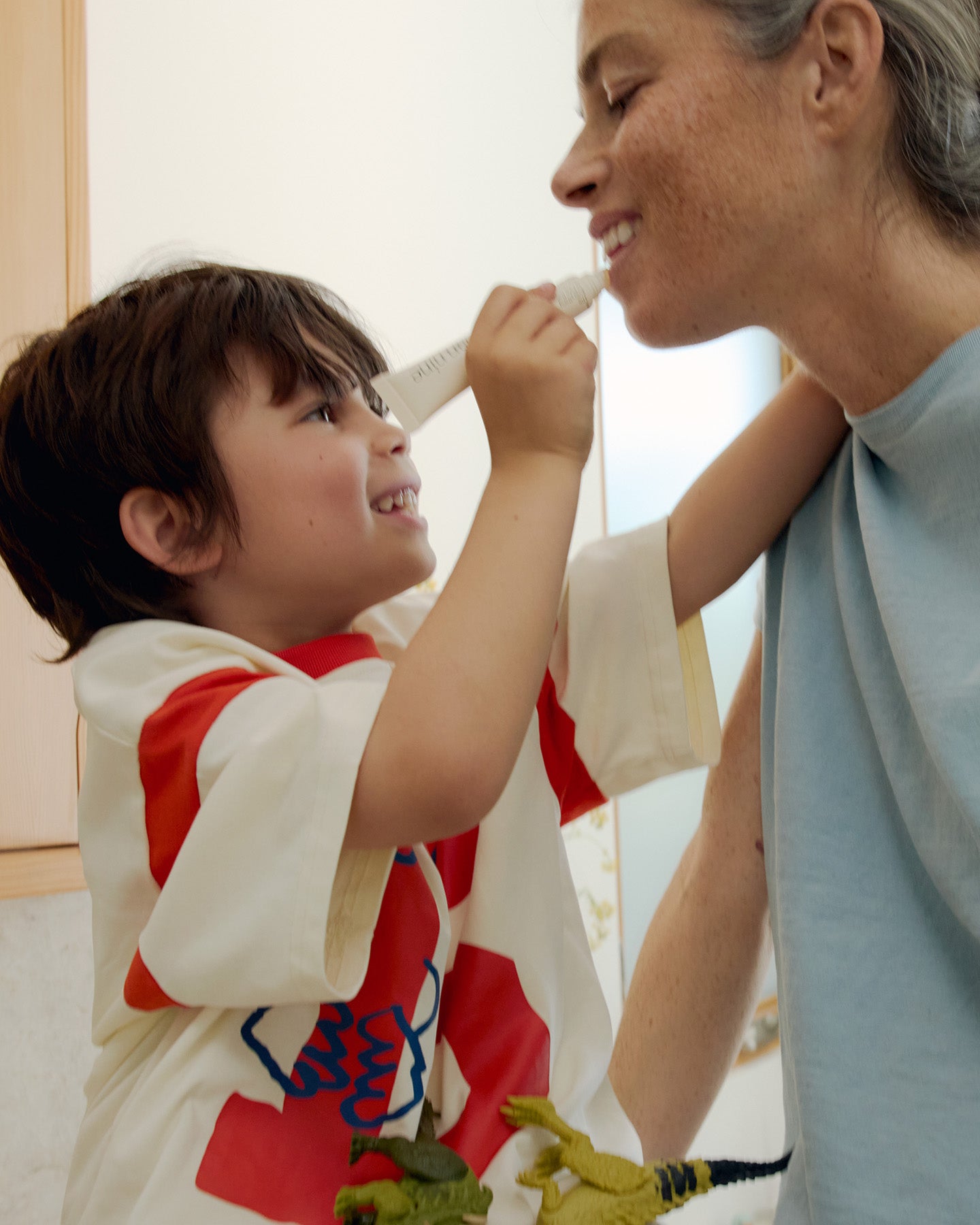Parent and child using The Everything is Fine Balm during a skincare moment