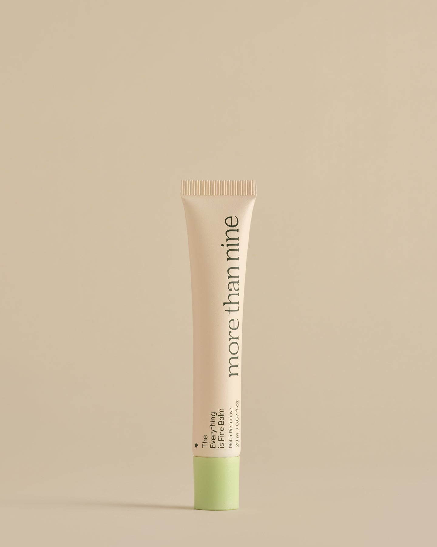 The Everything is Fine Balm tube on a neutral background