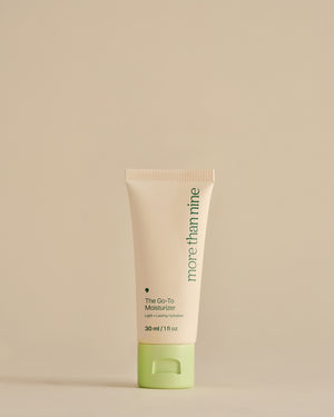 Travel-size The Go-To Moisturizer bottle on a neutral background