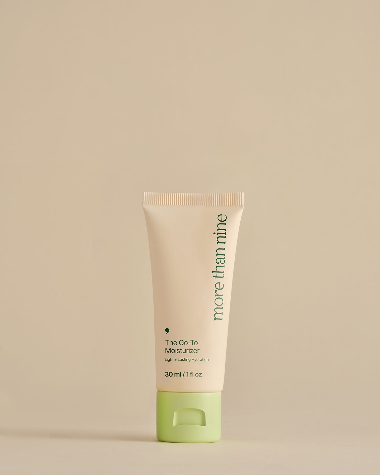 Travel-size The Go-To Moisturizer bottle on a neutral background